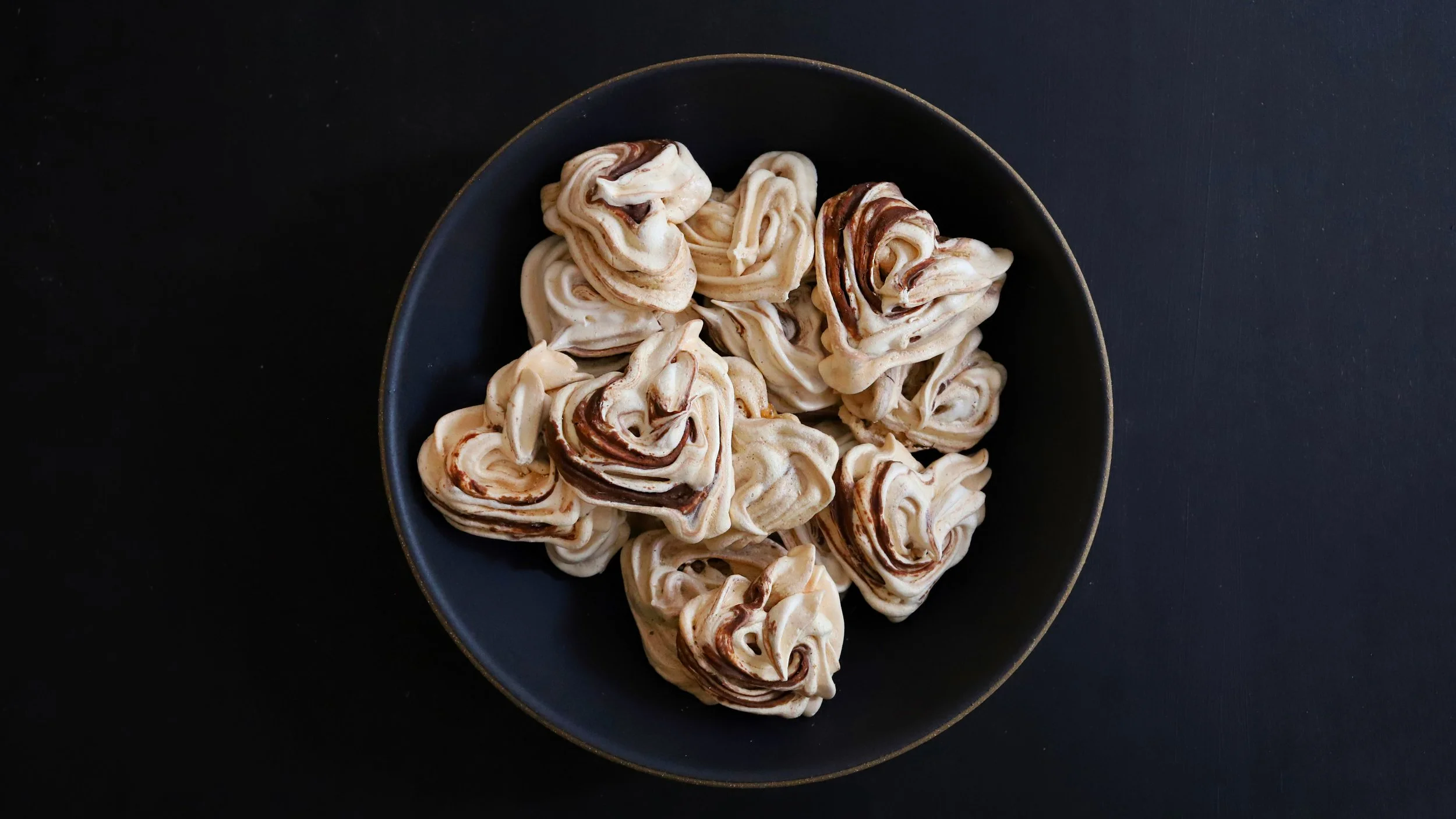 HEART-SHAPED FRENCH MERINGUE COOKIES WITH VANILLA, CARDAMOM, & CHOCOLATE SWIRL