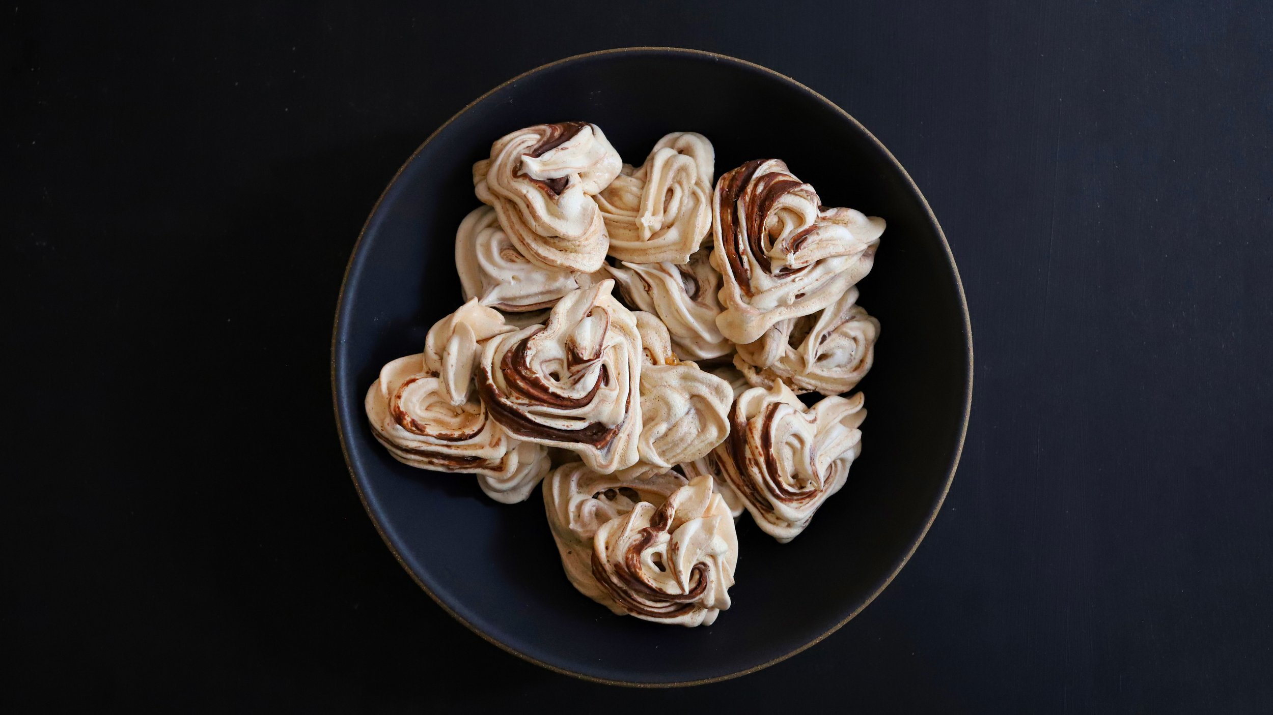 HEART-SHAPED FRENCH MERINGUE COOKIES WITH VANILLA, CARDAMOM, &amp; CHOCOLATE SWIRL