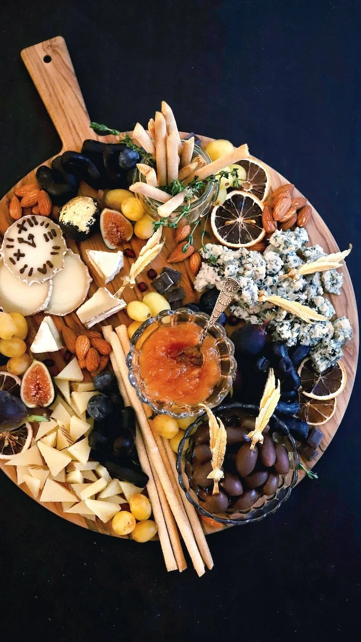 New Year's Eve themed cheeseboard with edible cheese clock.