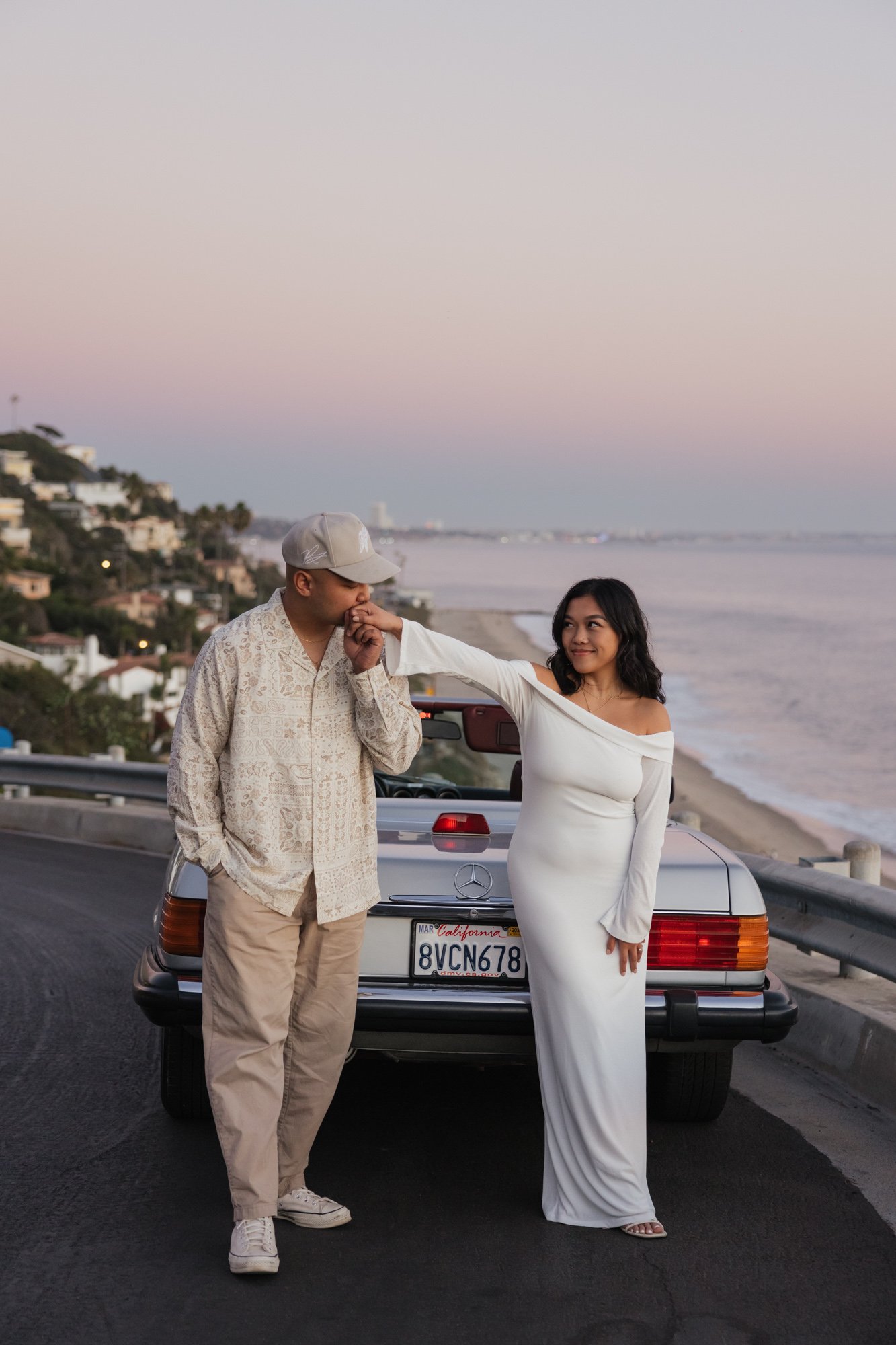 Golden hour engagement session in Malibu California with a vintage car overlooking the coast