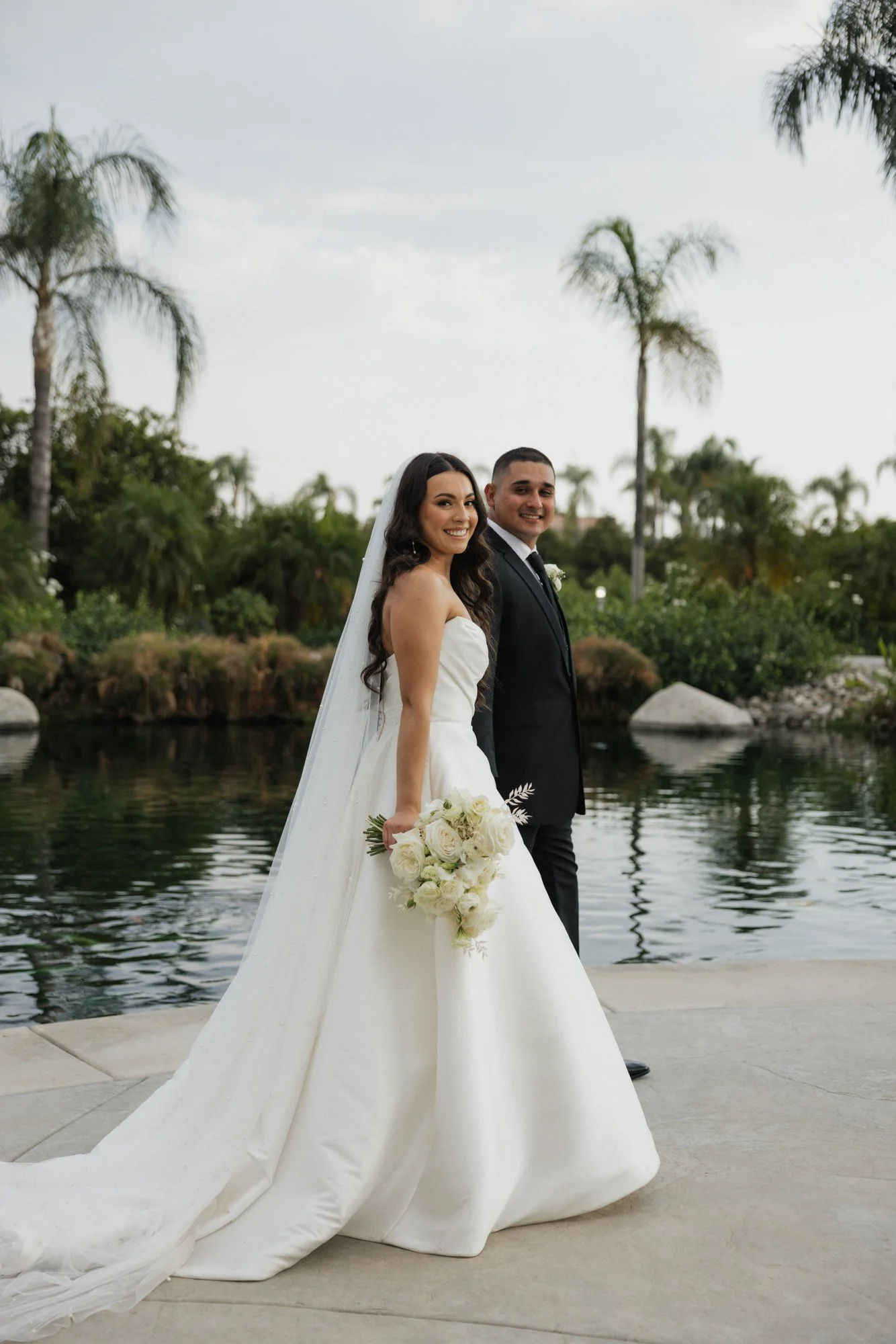 Editorial photographer poses bride and groom for intimate photos during a wedding at The Grove Redlands in Southern California