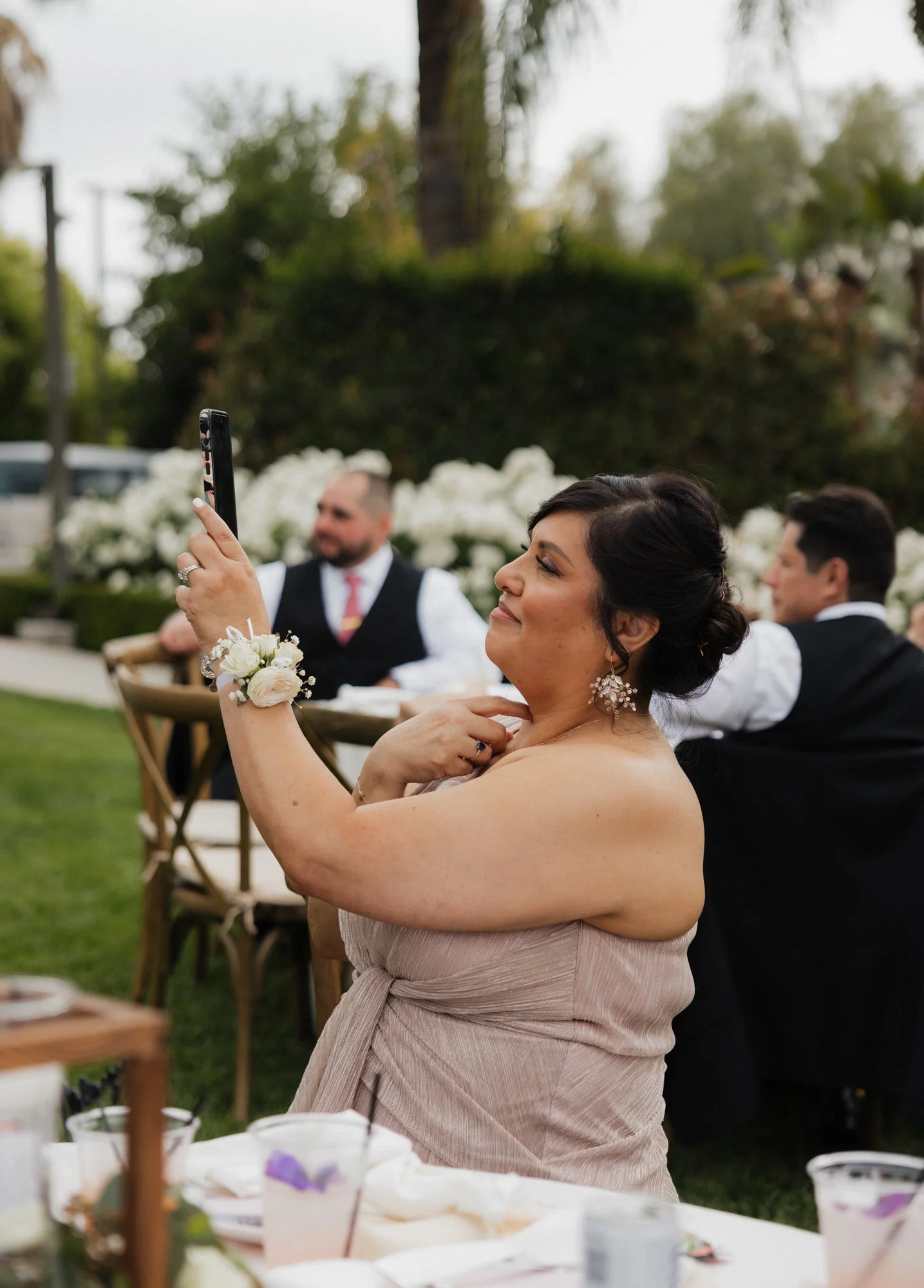 Candid photographer takes a candid photo of grooms mom during the wedding in Los Angeles California.