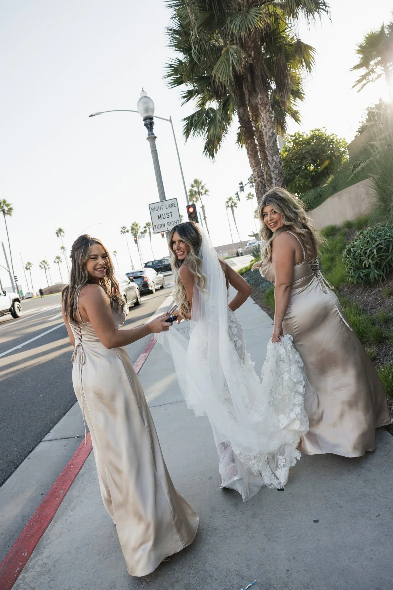Candid photographer takes a candid photo of a bride and bridesmaid in Huntington California.