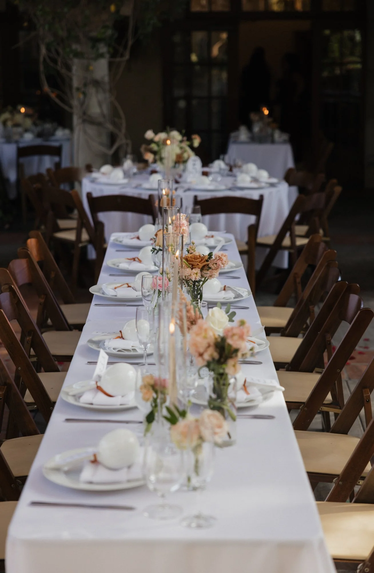 A candid photographer takes a detailed photo of table set up during wedding day in Los Angeles California.