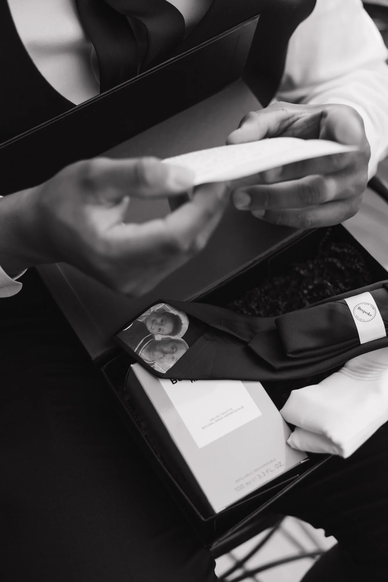 A candid photographer takes a detailed photo of gift he received from his wife on their wedding day in Los Angeles California.