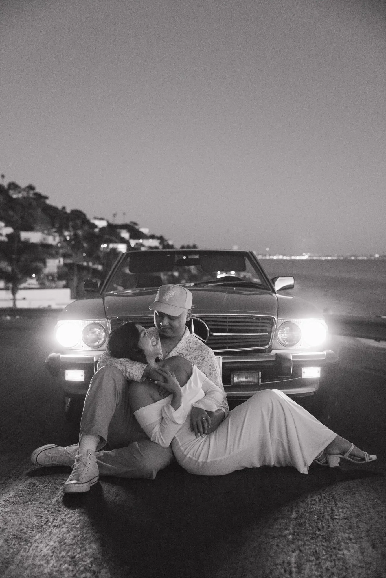 Golden hour engagement session in Malibu California with a vintage car overlooking the coast