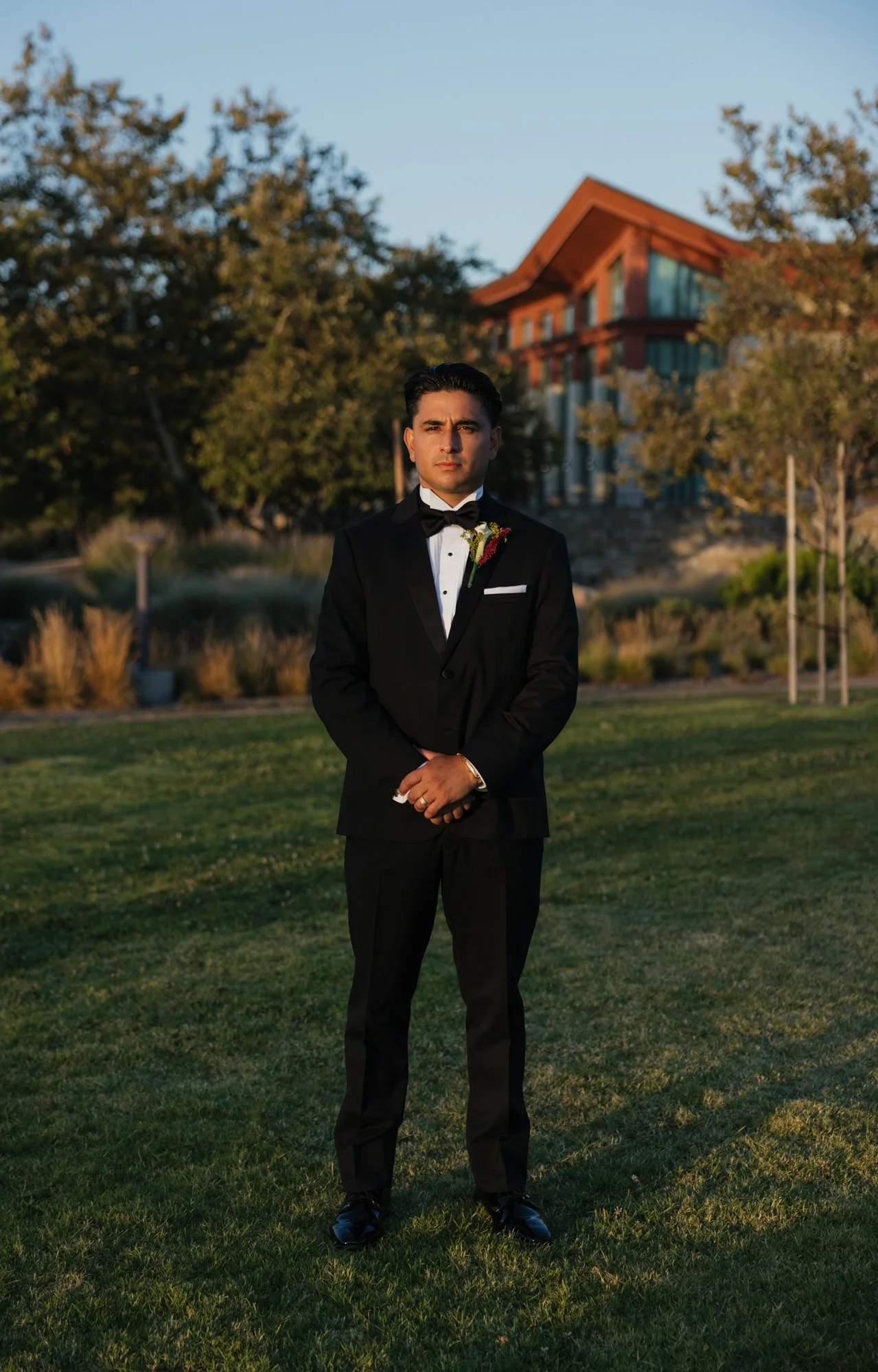 Editorial photographer takes editorial photo of groom during his wedding