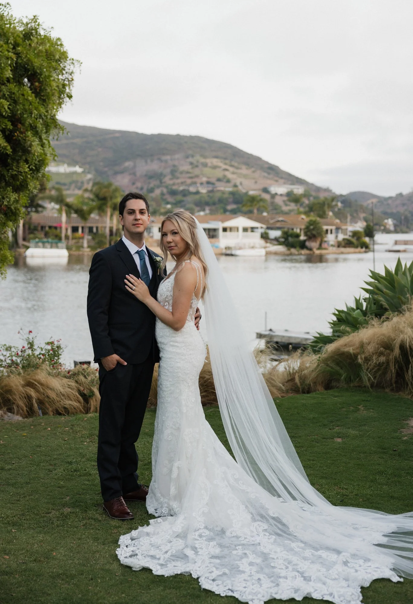 Editorial portrait of bride in groom by the lake in southern california by a editorial photographer