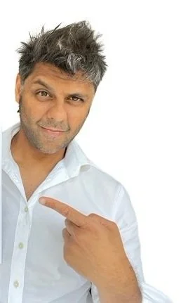 Man wearing a white shirt pointing with index finger
