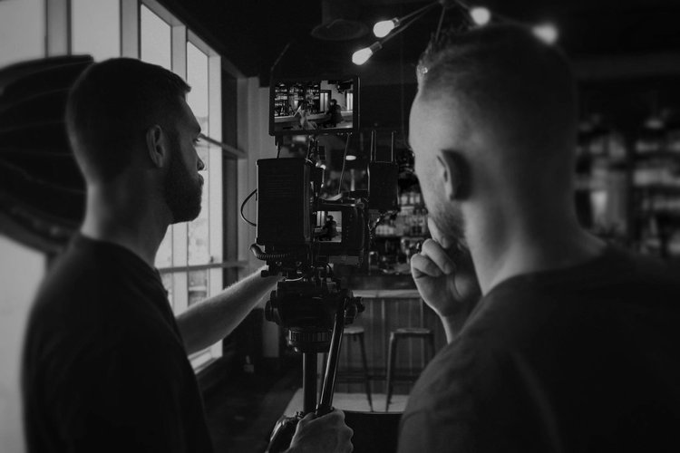 Two filmmakers reviewing a shot on a camera monitor