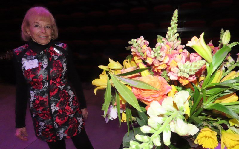   Volunteer Donna Beaux reveled in the beautiful bouquet that accompanied the hors d’oeuvres table.  
