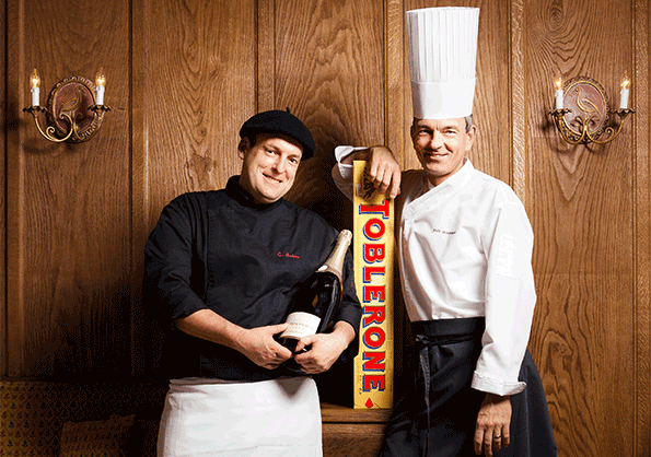 Two chefs posing with a giant Toblerone bar, corporate photography Switzerland, toblerone