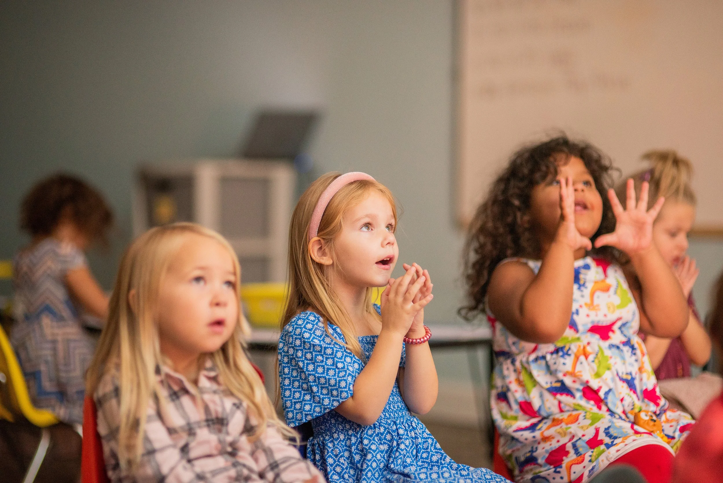 Man in Calvary Alliance Church shirt performing baptism on young girl in water