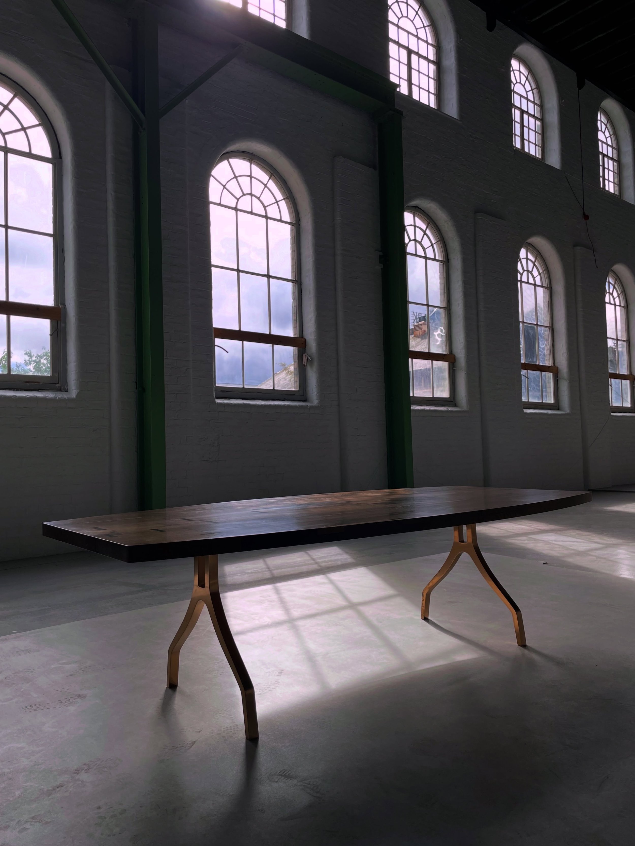 MAONAG DINING TABLE

More than just a dining table, it&rsquo;s the heart of the home. A place where family and friends gather to unwind, share stories, create lasting memories, and enjoy good food together. 

Fumed Oak top resting on solid bronze MAO