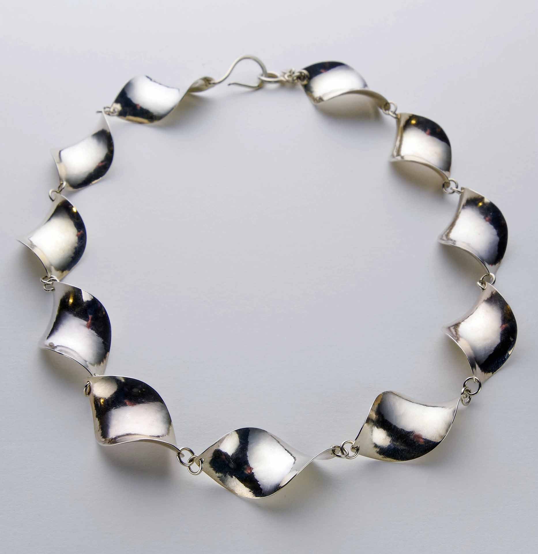 Hand-fabricated sterling silver necklace with complex curves