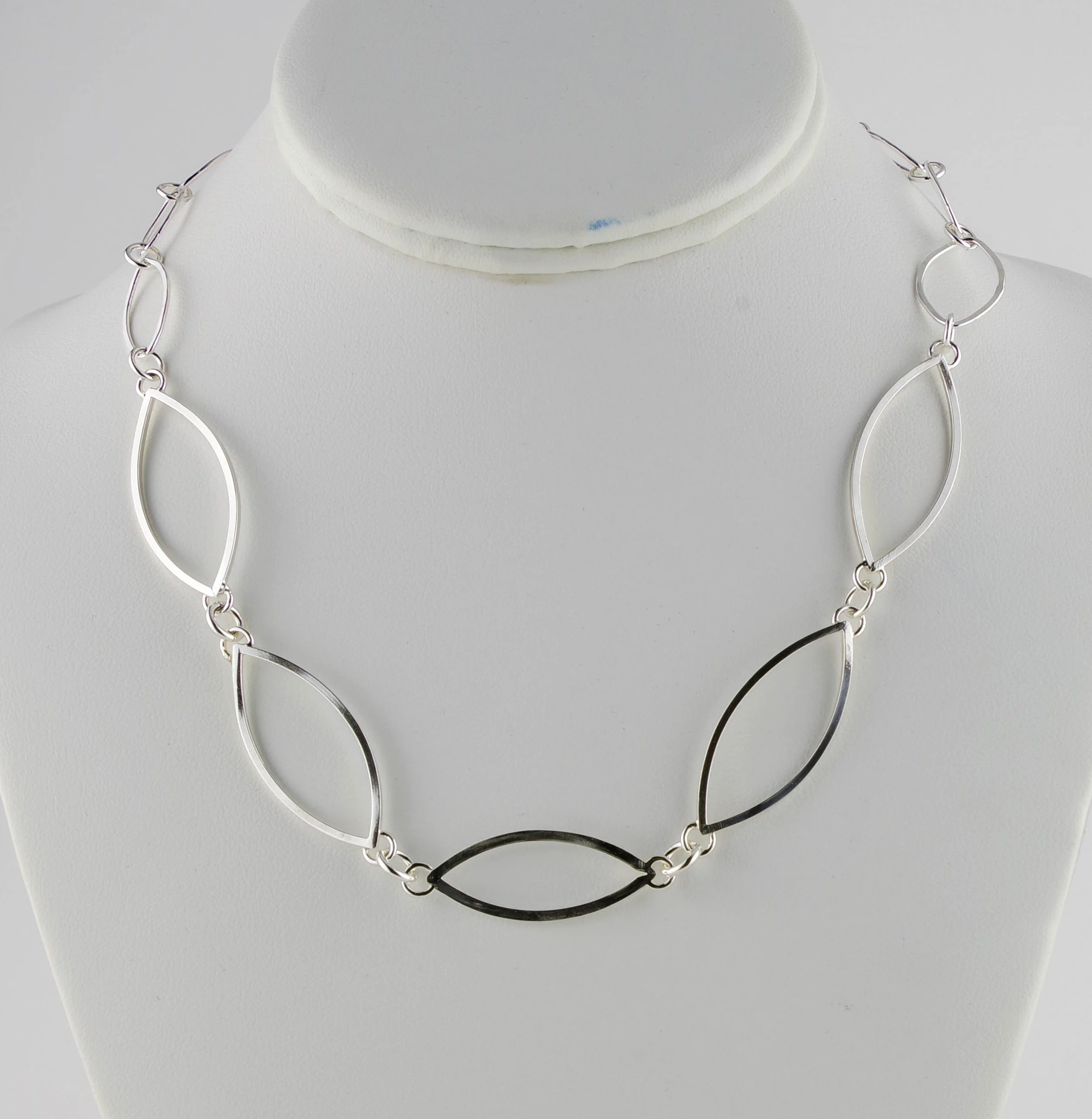 Sterling silver chain necklace with three sizes of leaf-shaped links.Leaf link necklace detail.jpg