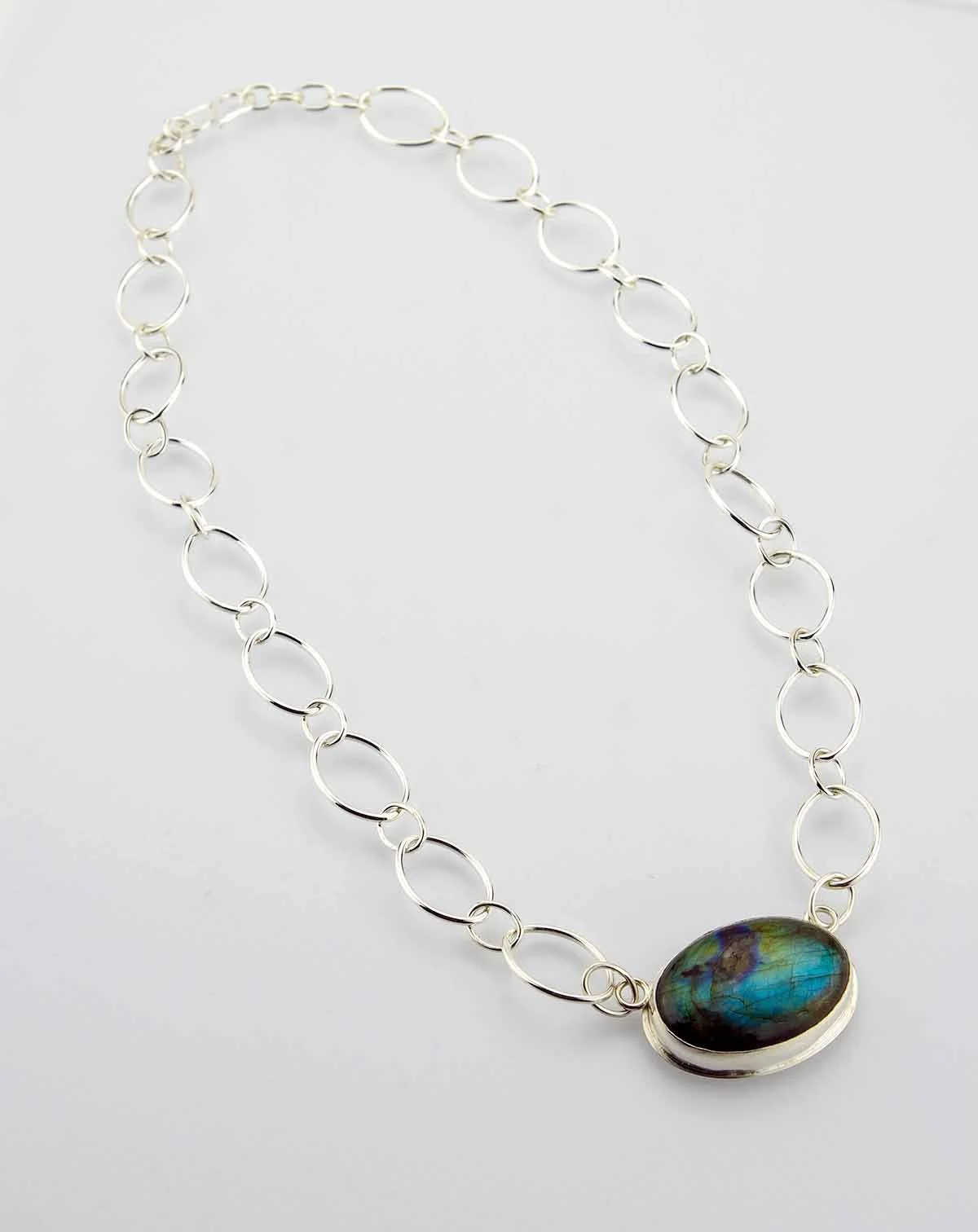 Oval labradorite stone in sterling silver setting on oval-link chain.