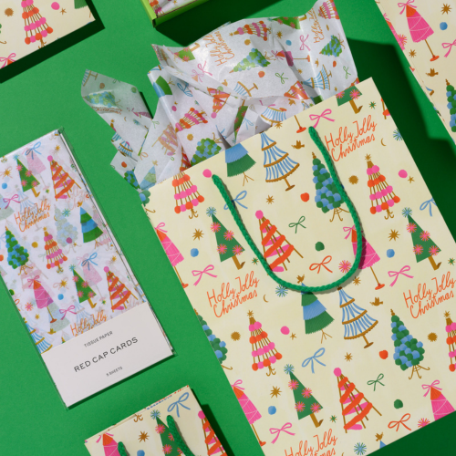 Christmas-themed gift bag with colorful decorated trees and the text 'Holly Jolly Christmas' on a green background.