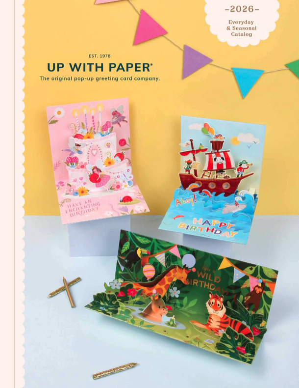 Catalog cover featuring paper floral arrangements with flowers in purple, pink, orange, and white, displayed against a green background. Three paper flower bouquets are arranged, including lily of the valley, chrysanthemums, and violets, each with a label and ribbon. The catalog is titled "Up with Paper" and mentions a 2025 catalog of everyday and seasonal greeting cards.