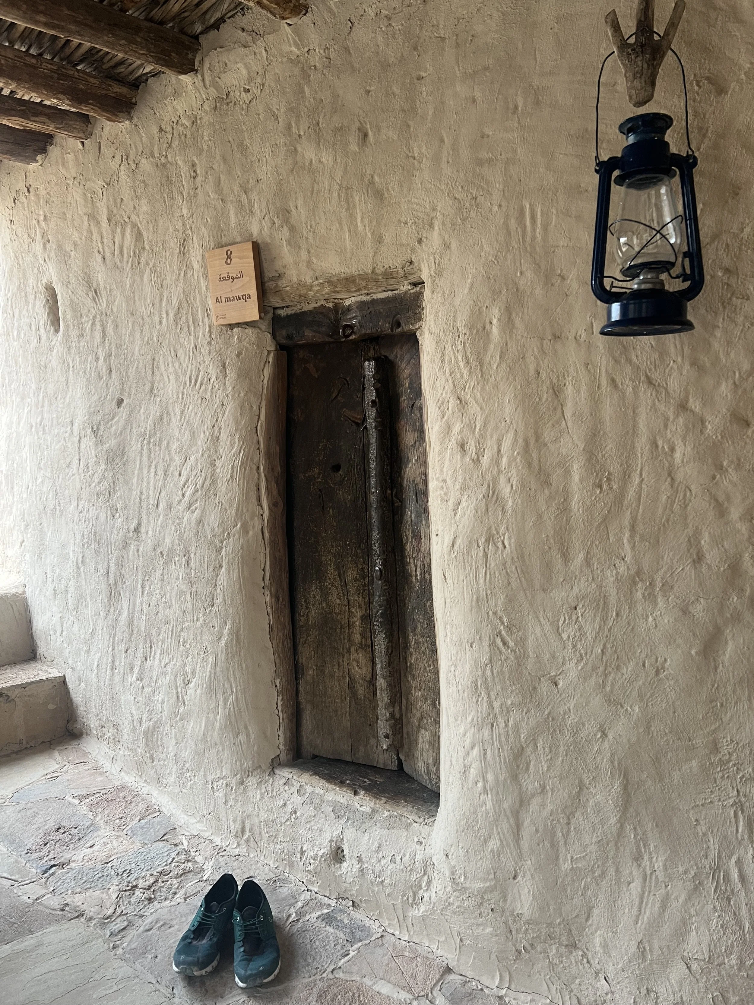 A traditional wooden door inside a cliffside home in Al Suwgra, reflecting local building techniques and daily life in Oman’s Hajar Mountains.