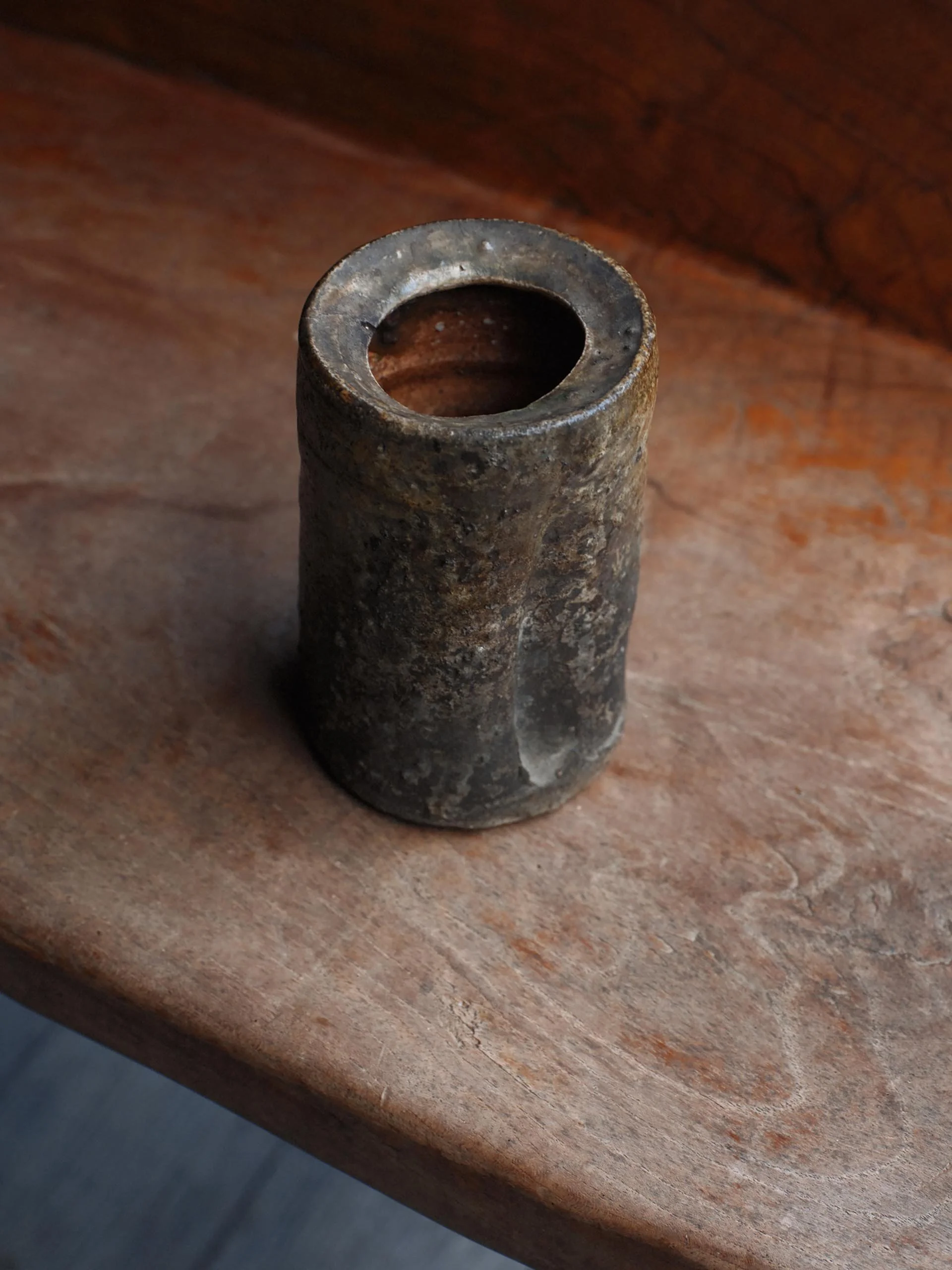 Overhead view of a Shigaraki ceramic resin vessel, revealing its cylindrical form and wide mouth, shaped by years of practical use and fire exposure