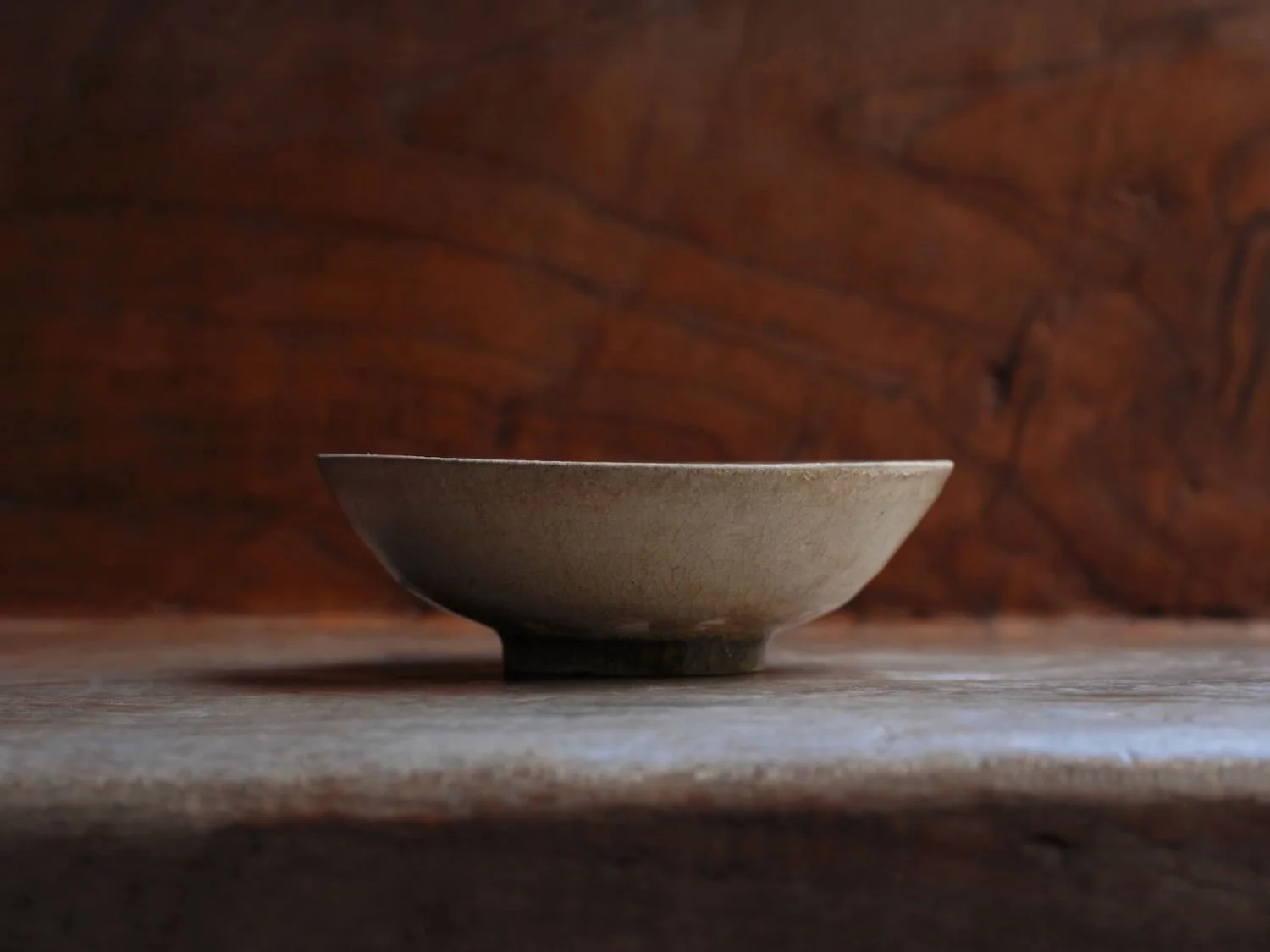 Profile view of a Vietnamese Lê Period vessel, emphasizing its refined proportions and softly textured, crackled glaze surface