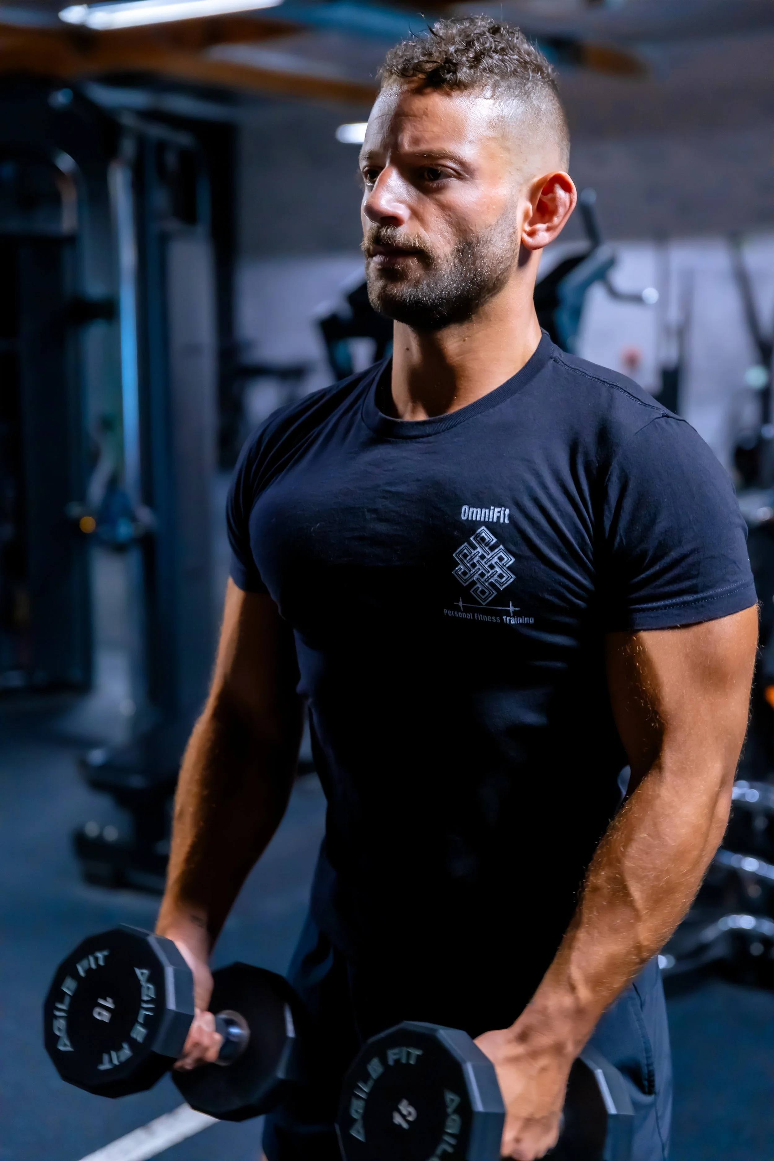 Nemezio Lopez performing a 30-minute executive reset workout with dumbbells at home