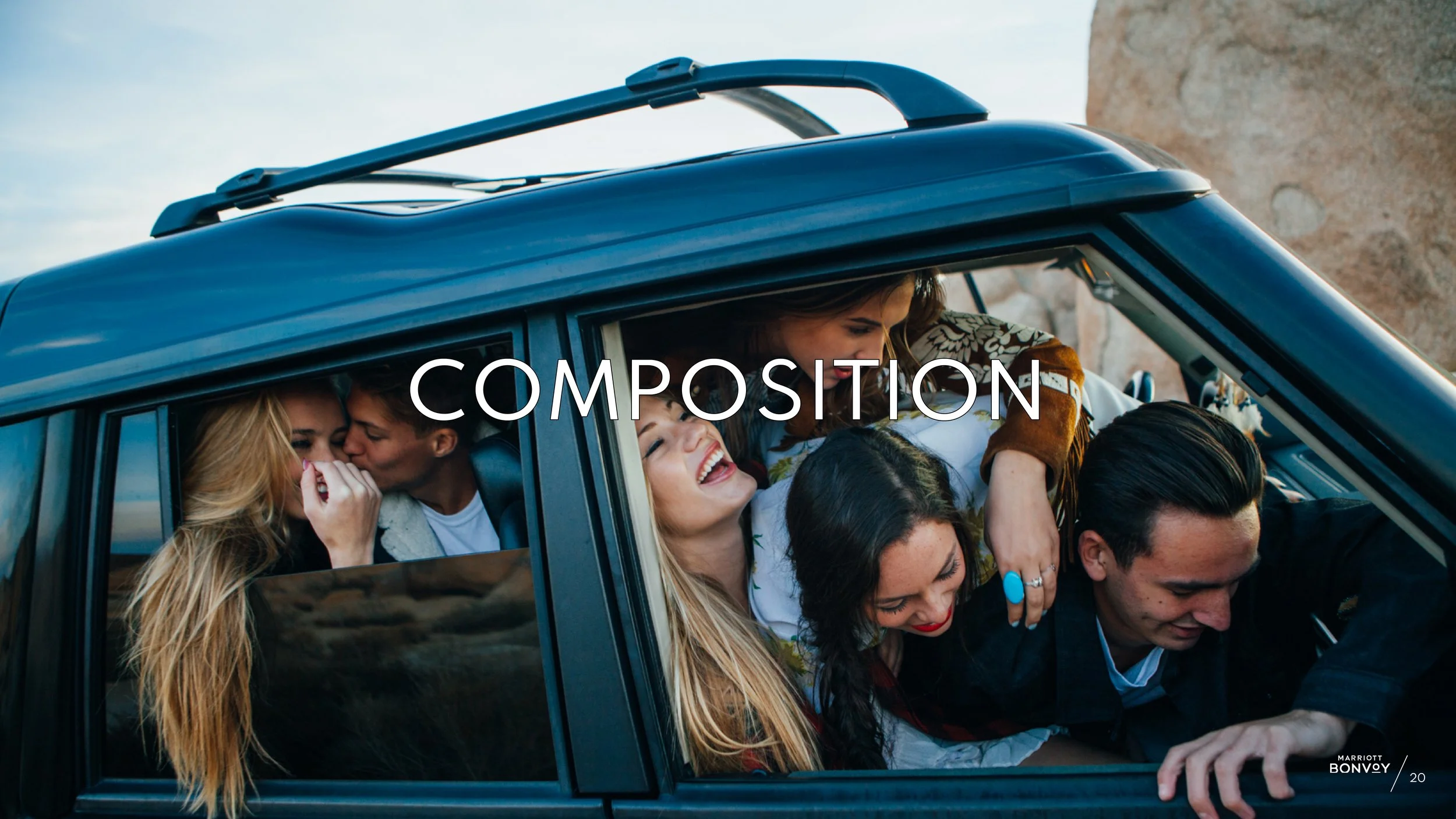 A car is full of young adults, laughing and being pushed towards the windows