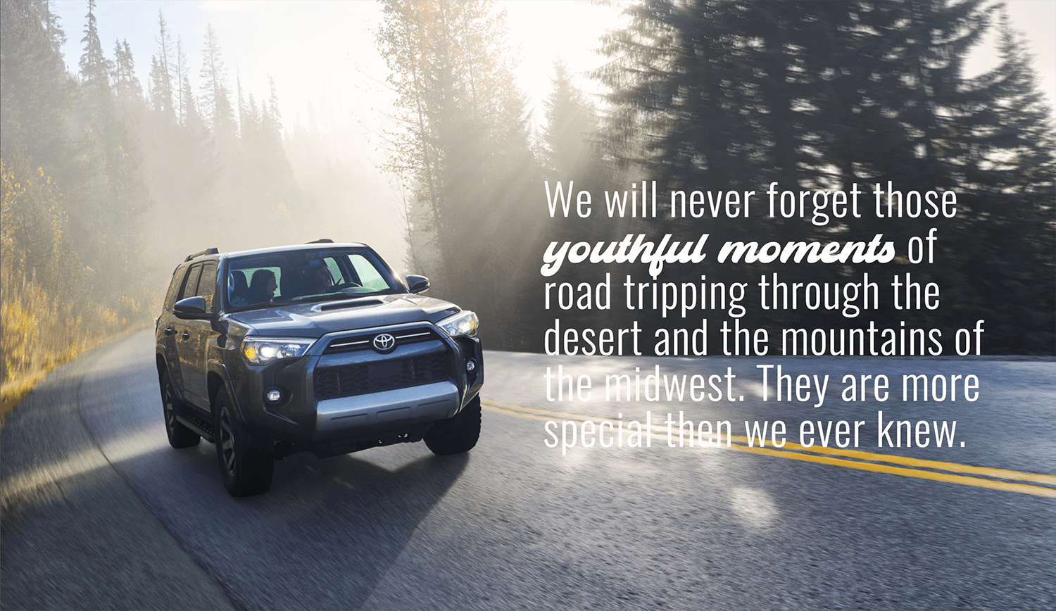 Toyota SUV driving around a curvy road in the morning light.