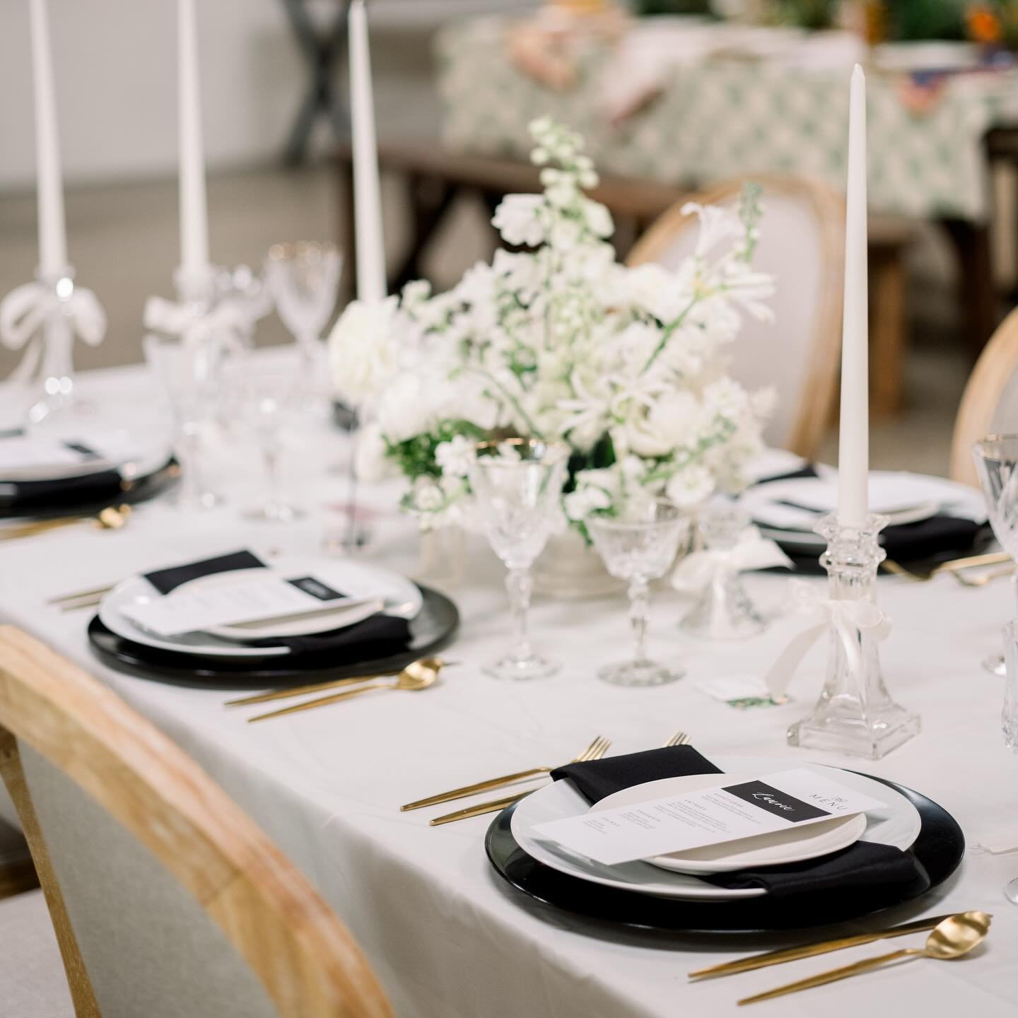 From the sleek lines to the delicate bows, every detail of our black and white tablescapes whispers elegance. Ask us about our new charger and white plate-ware options and let our tabletop rentals transform your event into a masterpiece. 
.
Florals: 