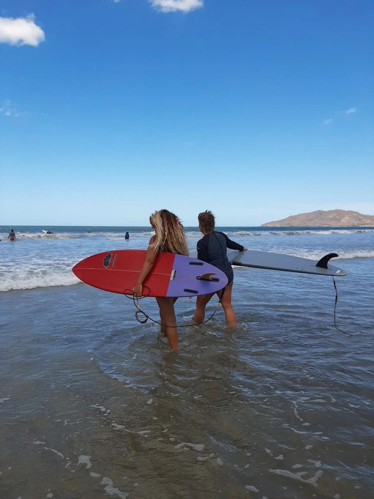 Tracy and friend walk into ocean