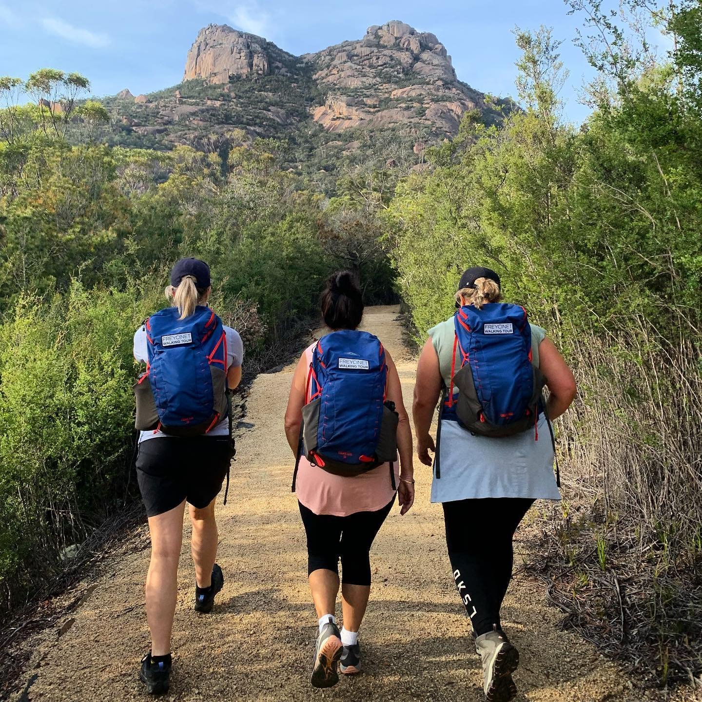 FWT ladies walking away w branded packs.jpeg