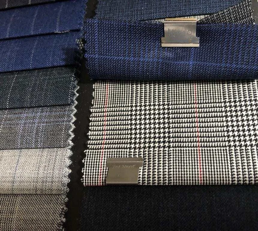Swatches of navy and black-and-white glen plaid suiting fabric