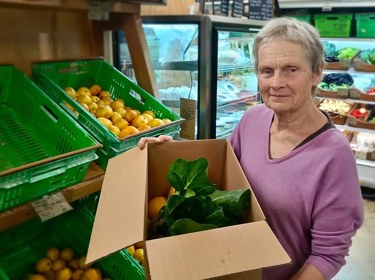 Staff with produce at the shop