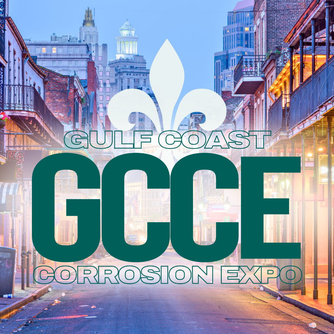 City street at dusk with buildings, some with balconies, and a large sign for Gulf Coast Corrosion Expo featuring a fleur-de-lis symbol.