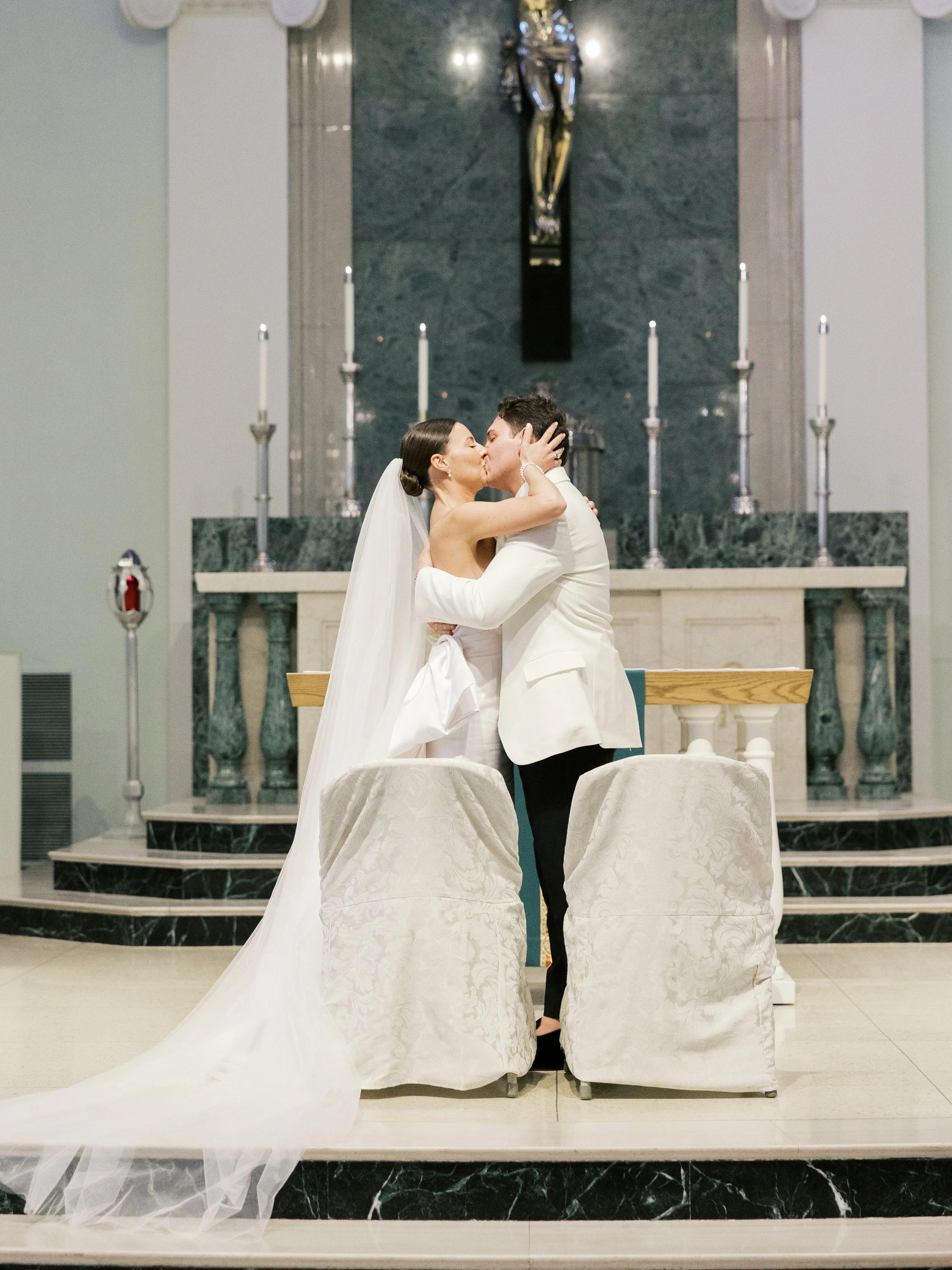 Bride and groom kissing in a church ceremony