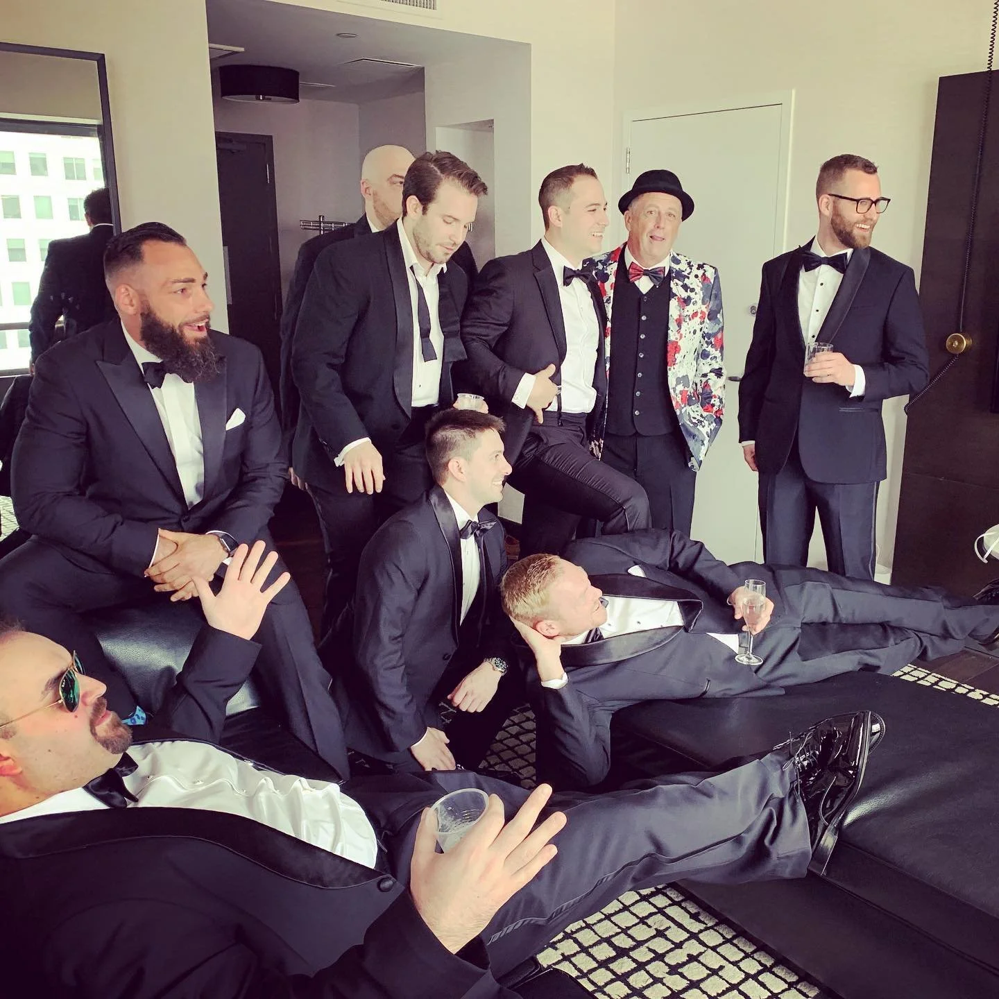 Group of men in suits posing in an indoor setting