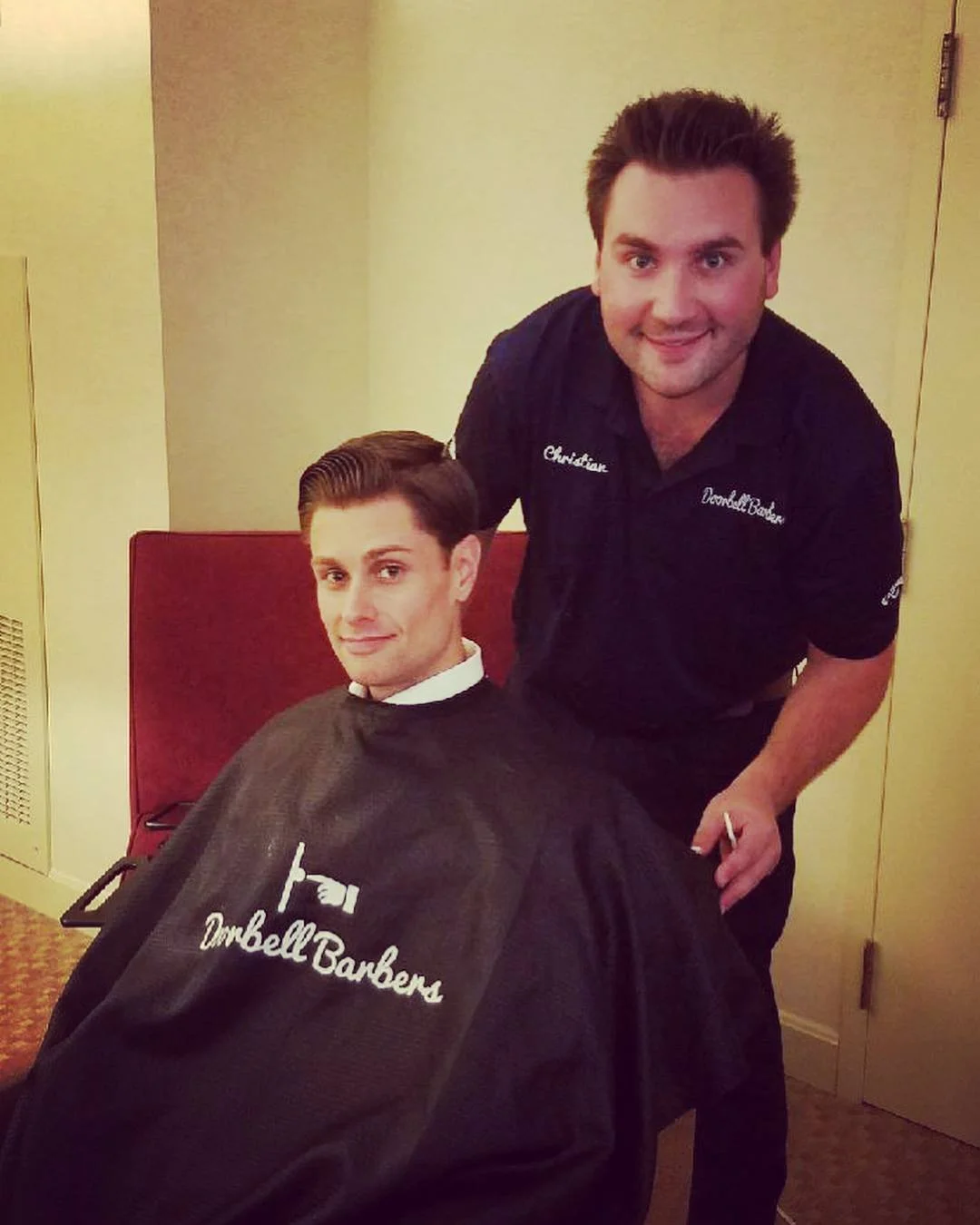 Barber and client during haircut session indoors