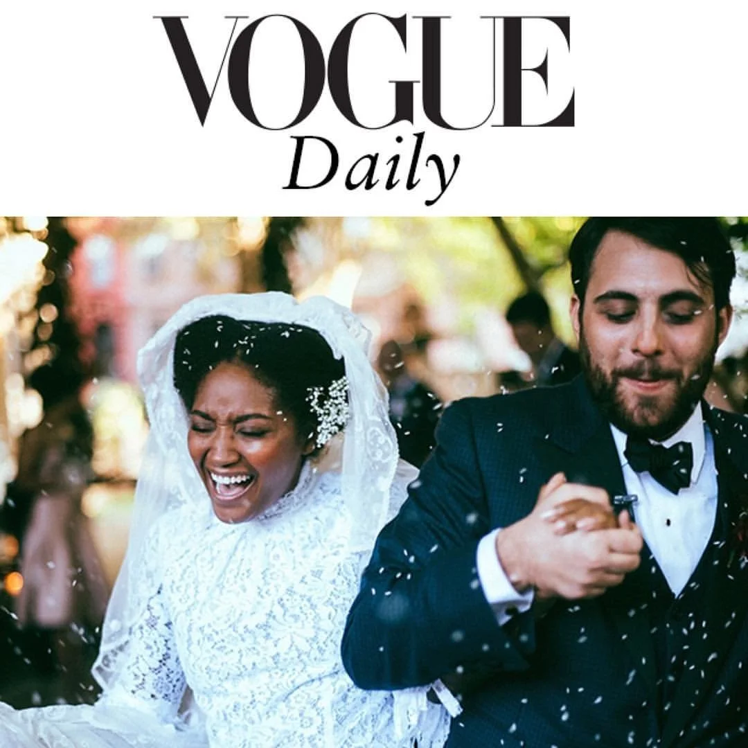 A joyful wedding scene with a bride in a lace gown and veil, and a groom in a suit, under the Vogue Daily logo.