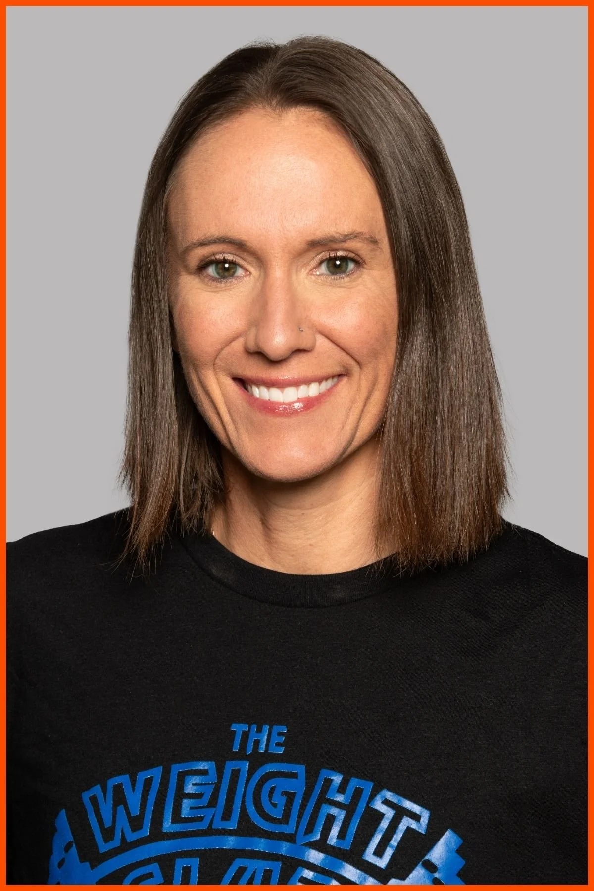A portrait of The Weight Club assistant general manager, Laura Blackburn wearing a black t-shirt with The Weight Club logo in the center of the chest.