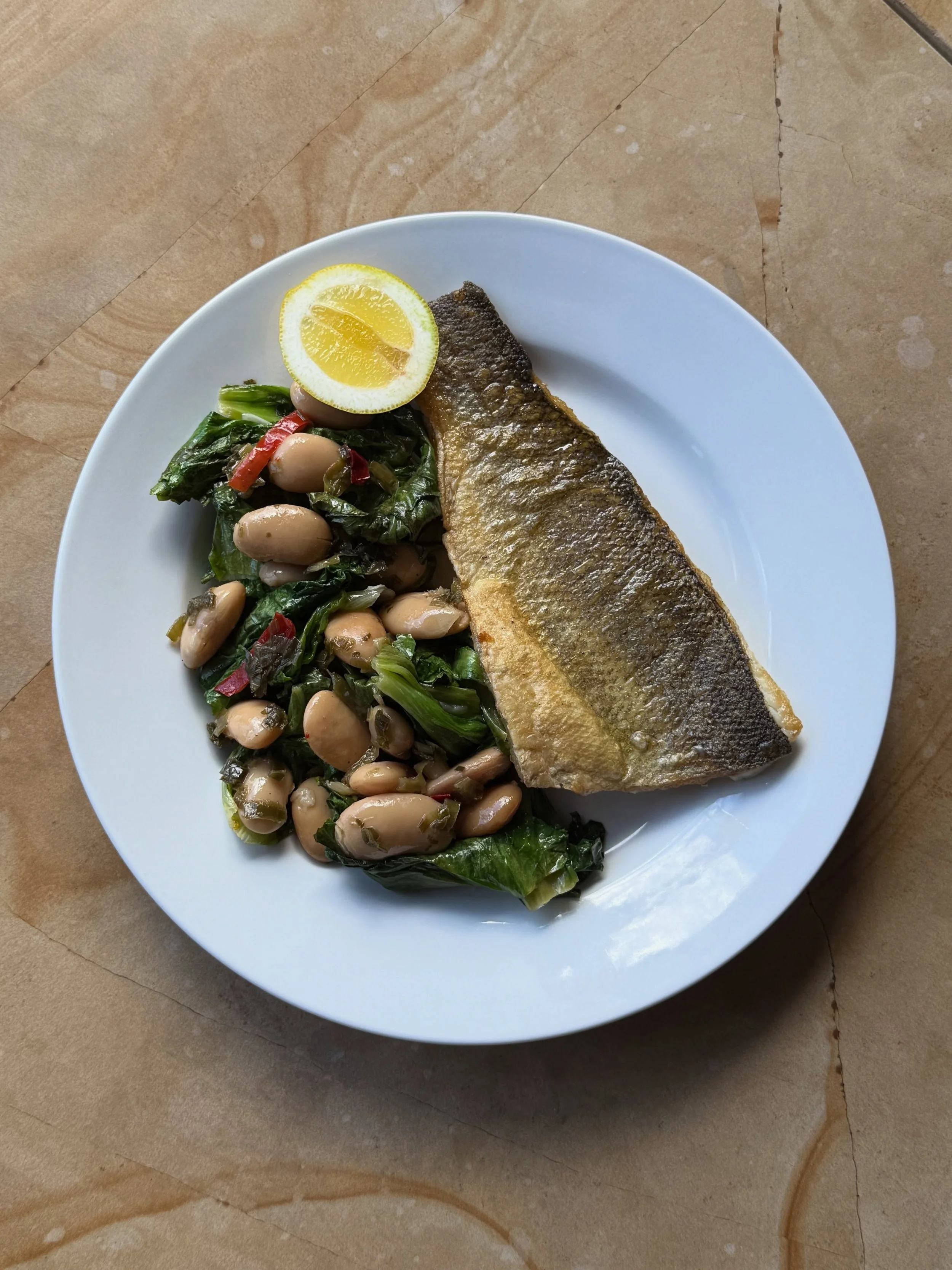 Bright, balanced, and just right for spring &mdash; seared branzino with saut&eacute;ed escarole and marinated beans