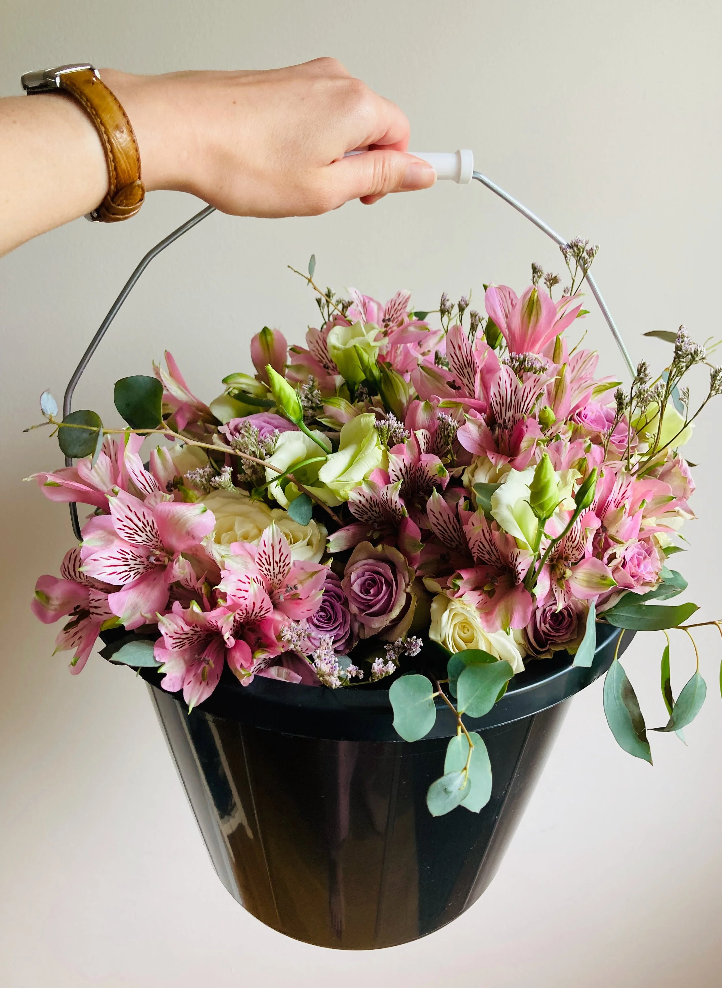 bouquets of flowers in a bucket