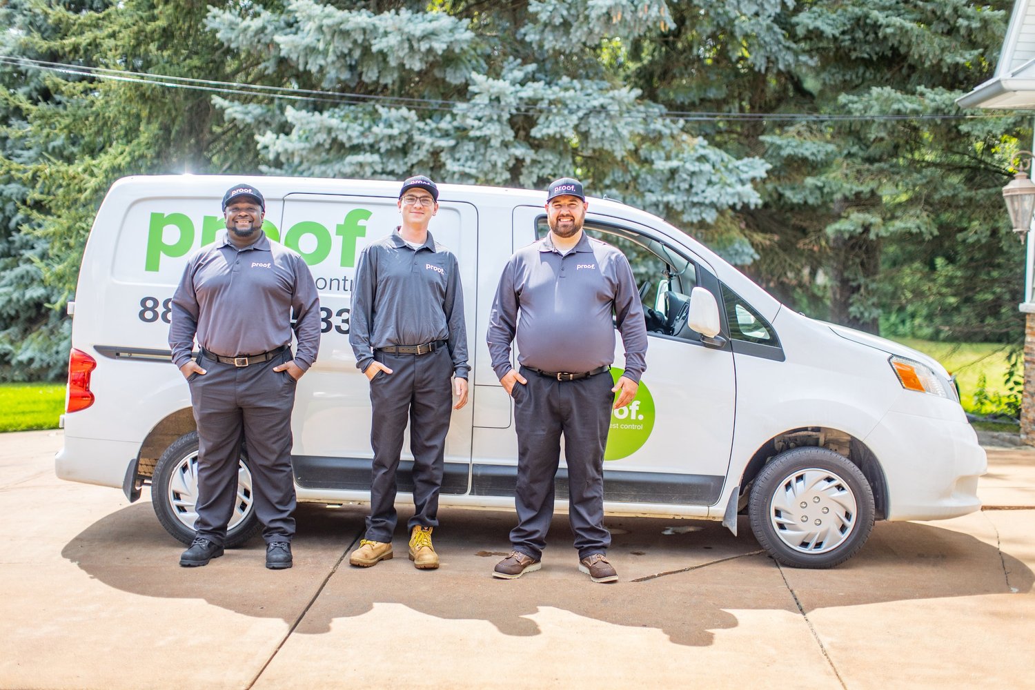 Proof Pest Control technicians beside their service van