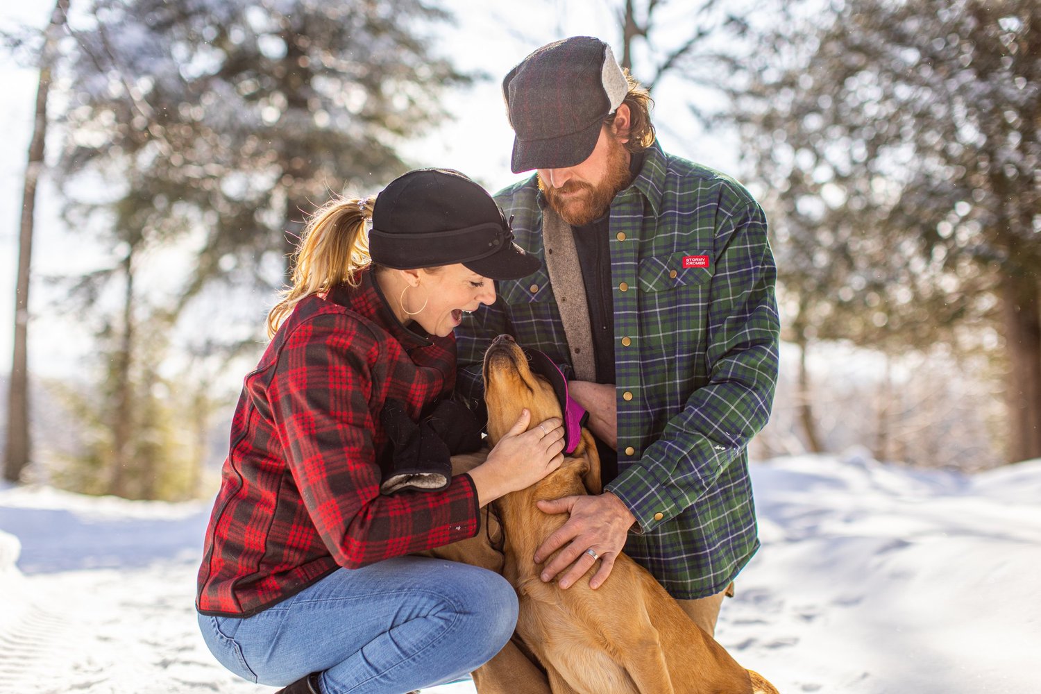 Couple and dog in Stormy Kromer winter wear