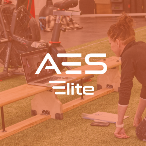 A woman working on a woodworking project with a laptop on a wooden beam indoors.