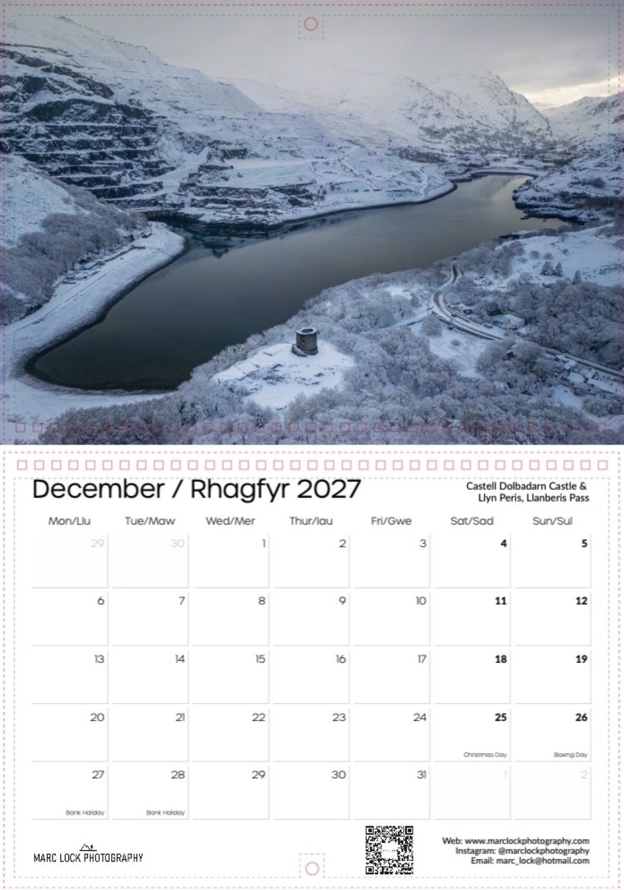 A calendar for December 2027 featuring a photograph of Rhagfyr, Wales, including Castelli Dolbadarn Castle and Llyn Peris in Llanberis Pass, with snow-covered mountains and a winding river.