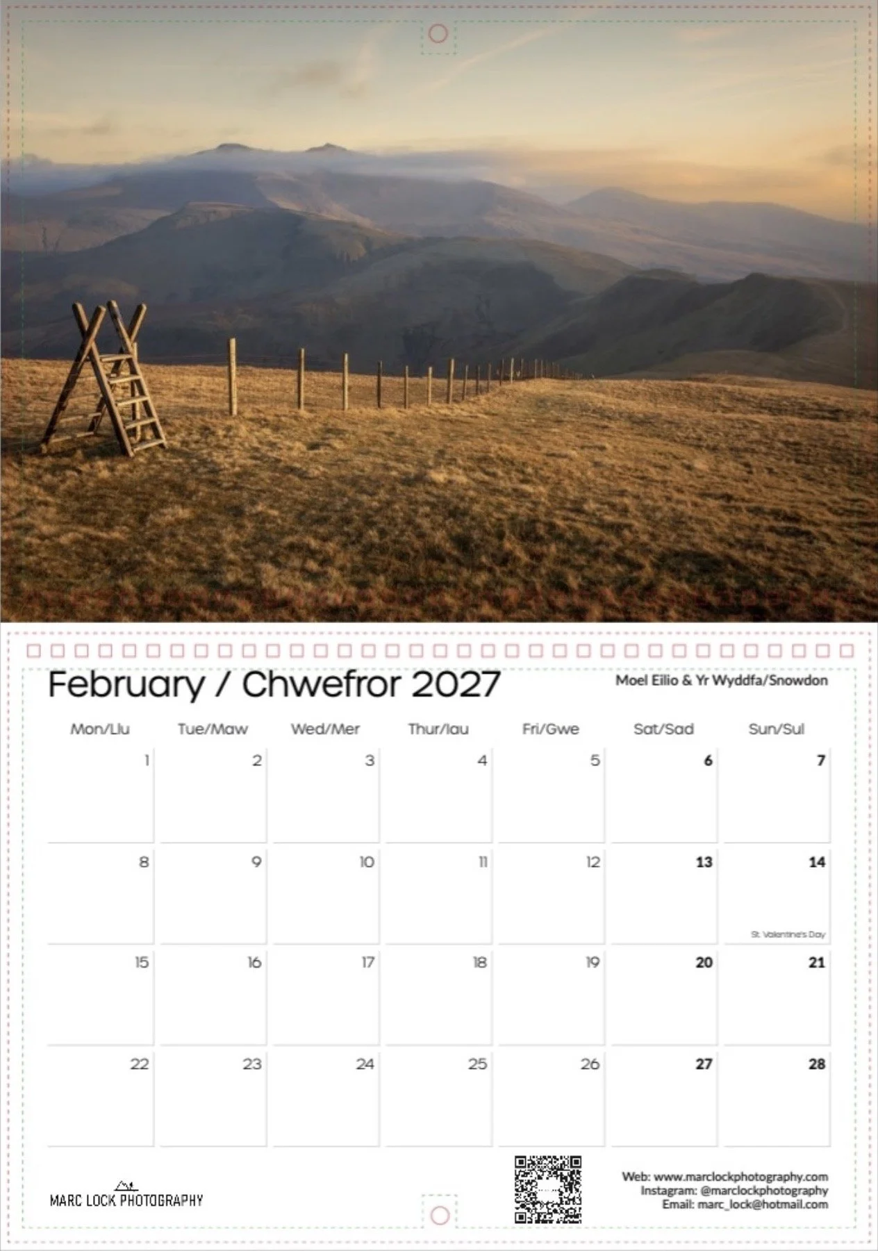 A landscape photograph of rolling hills and mountains at sunset, with a wooden ladder and fence in the foreground.