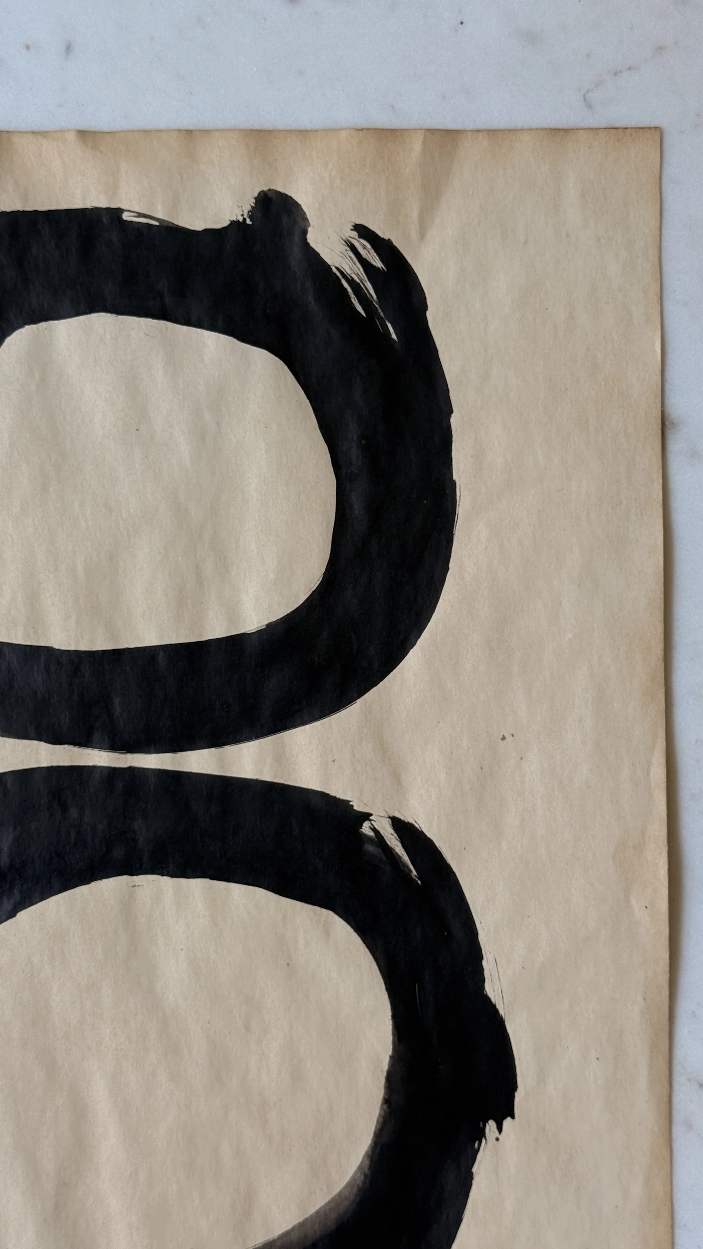 Original abstract ink artwork featuring hand-painted black circles stacked vertically on warm vintage paper.