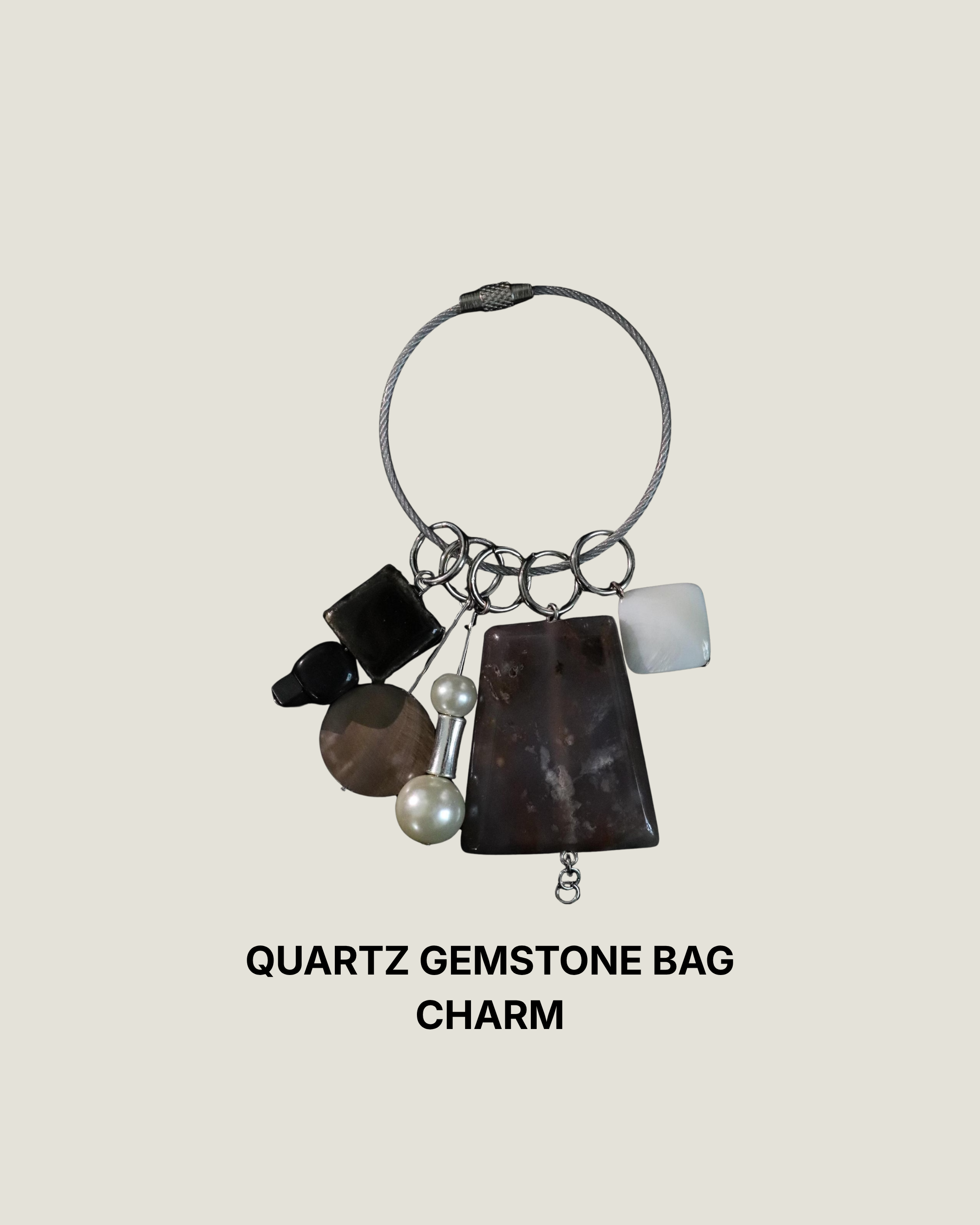 Quartz gemstone bag charm with pearls, glass, and silver dangles on a cable ring