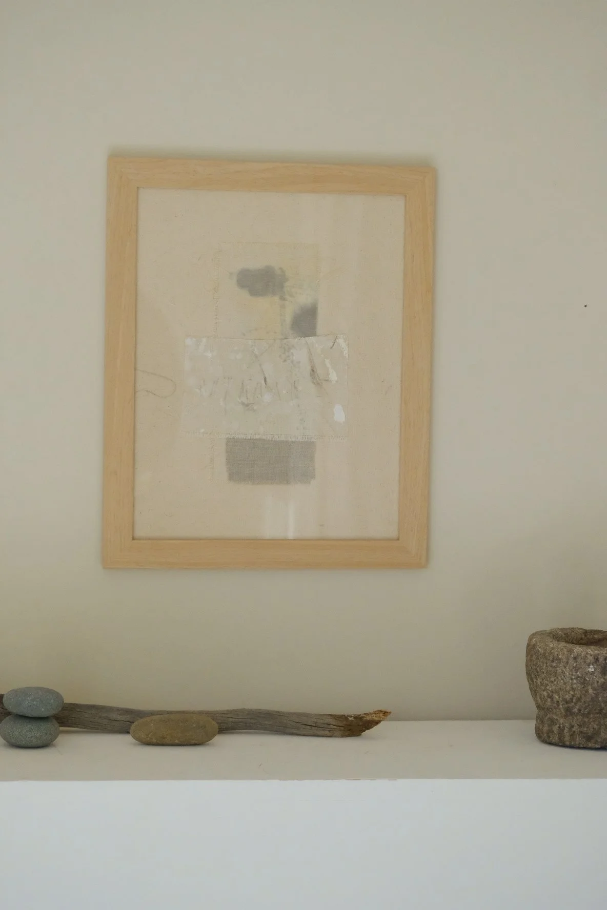 Framed 11 x 14 collage of layered canvas panels and a grey cloth patch with soft grey marks